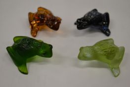 Four Lalique opaque glass frogs.