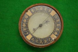 A Chinese wooden cased compass.