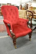 A Victorian mahogany framed button upholstered armchair.