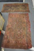 Two small worn Persian rugs 145cm x 85cm and 134cm x 75cm.