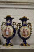 A pair of Continental decorative twin handled vases.