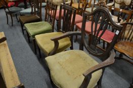 Four various dining chairs, one with arms.