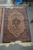 A good small Persian part silk rug, cream ground with floral decoration 128cm x 82cm.