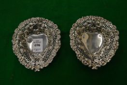 A pair of silver heart shaped bonbon dishes.