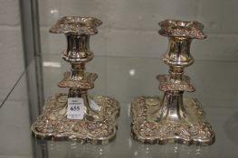 A pair of plated candlesticks.