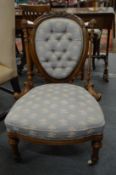 A Victorian walnut framed button upholstered bedroom chair.