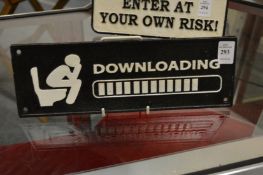 A novelty cast iron sign.