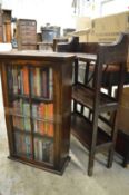 Two small oak bookcases with various books.