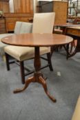 A mahogany tilt top tripod table.