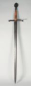 A large hand and a half broad sword with cruciform hilt and tolodo blade.