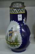 A large delft pottery jug with pewter lid.
