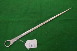 A silver meat skewer.