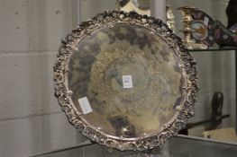 A good plated circular salver with cast border.