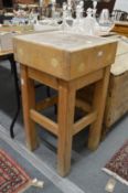 A small butchers block on stand.