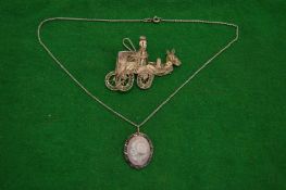 A silver filigree brooch pendant and chain.