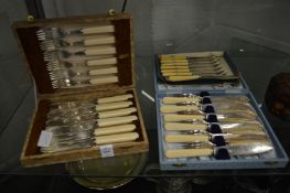 Two cased sets of fish knives and forks and a set of butter knives.