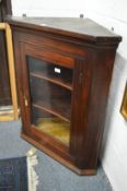 A mahogany hanging corner display cabinet.