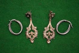 Two pairs of silver earrings.