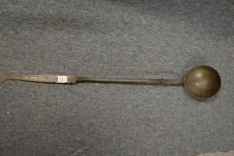 A large Dutch metal ladle.