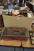 Old tins and a Schweppes wooden box.