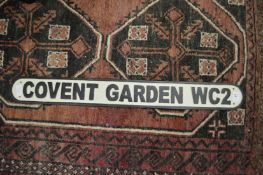 A novelty cast iron sign.