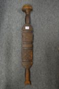 An Eastern carved wood paddle or club.
