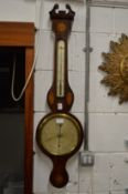 A mahogany barometer/thermometer.