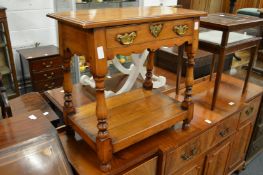 A small 17th century style two tier occasional table.