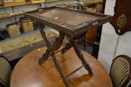 An Eastern carved hardwood tray table.