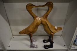A carved wood figure of two ducks.