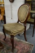 A set of four Victorian walnut dining chairs with upholstered backs and seats.