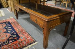 A mahogany coffee table with inset leather top.
