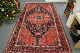 A good Persian design carpet, red and blue ground with stylised decoration 270cm x 155cm.