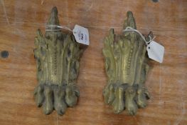 A pair of cast bronze claw shaped furniture mounts.