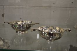 Two silver porringers.
