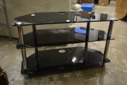A glass three tier corner TV stand.