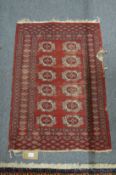A small Bokhara rug (worn), 89cm x 62cm.