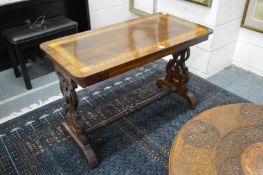 A Victorian inlaid rosewood stretcher table.