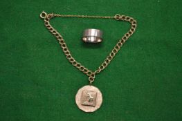 A silver bracelet, a pendant and ring.