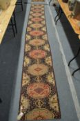A machine made stair or hall runner 440cm x 57cm.