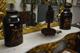 A pair of Toleware style storage canisters with armorial decoration.