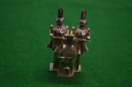 A silver miniature model of a church.