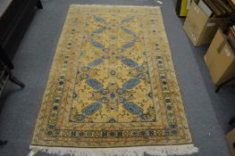 A Persian design rug, gold ground with stylised decoration 200cm x 126cm.