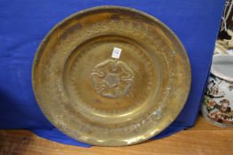 An embossed brass circular charger.