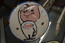 A circular enamel sign.