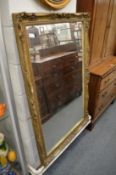 A large gilt framed mirror.
