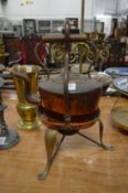 An unusual copper kettle on stand.
