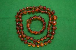 A suite of amber bead jewellery, necklace, bracelet, and earrings