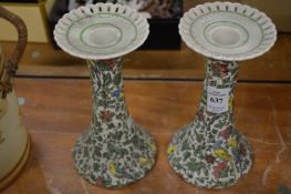 A pair of royal Doulton Persian pattern candlesticks.