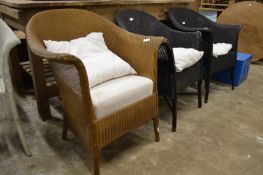 Three Lloyd Loom chairs.